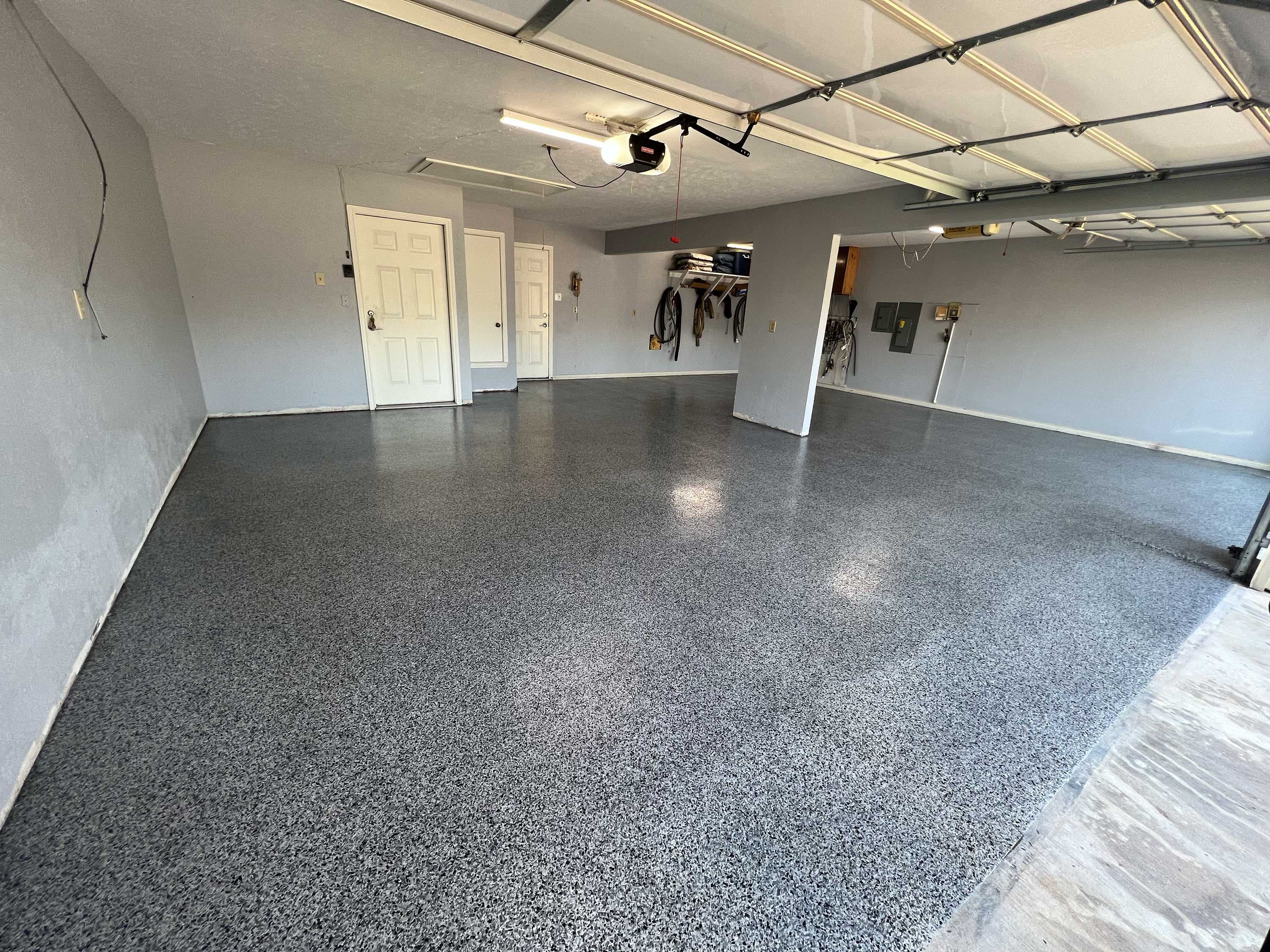 Completed garage epoxy flooring with decorative finish